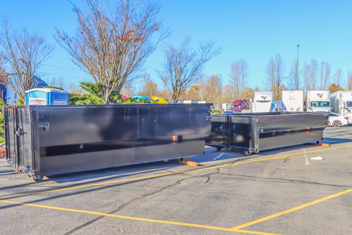 Professional dumpster rental service with roll-off container on residential driveway in Mountainside